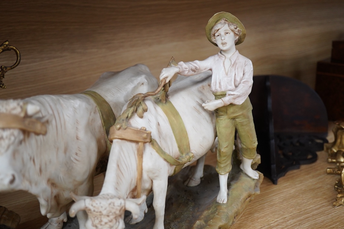 A large Royal Dux porcelain group of a pair oxen with a farm hand, pink triangle mark. 38cm wide